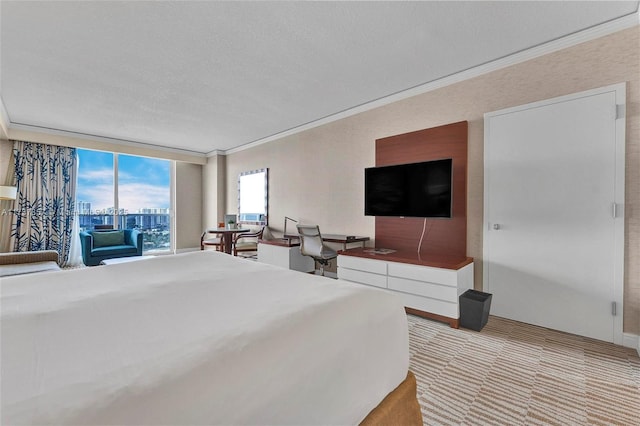 bedroom with a textured ceiling, expansive windows, light colored carpet, and crown molding