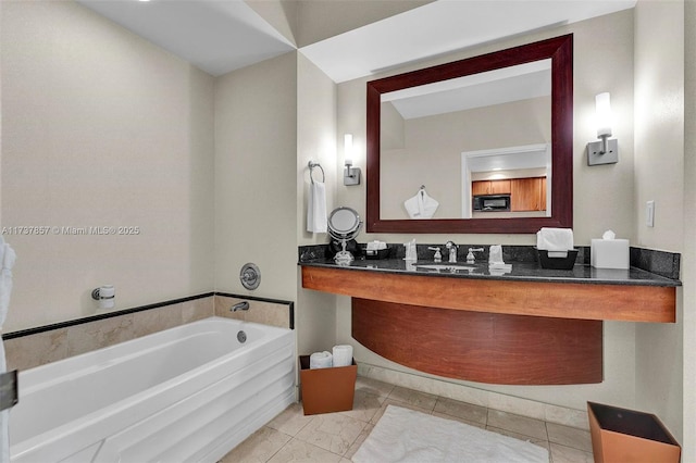 full bath featuring a garden tub and vanity