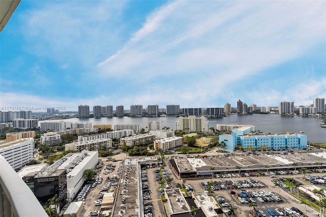 drone / aerial view featuring a water view and a view of city