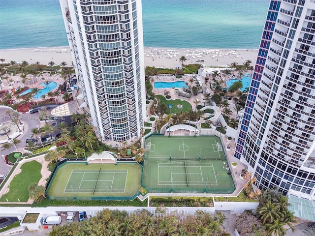 birds eye view of property with a view of city, a water view, and a beach view