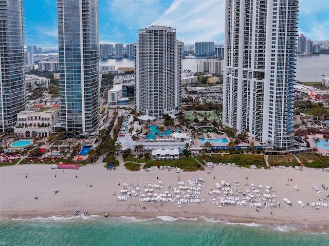 bird's eye view featuring a view of the beach, a water view, and a city view