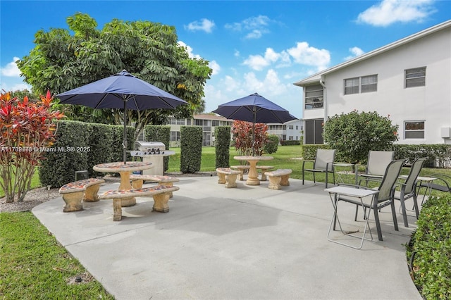 view of patio with fence and a grill