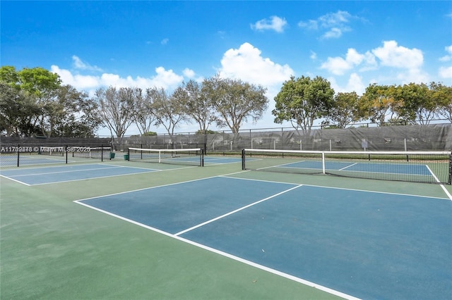 view of tennis court featuring fence