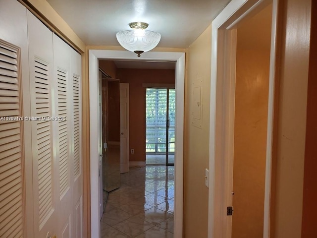 corridor featuring light tile patterned floors