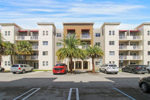 view of building exterior with uncovered parking