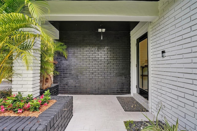 property entrance featuring brick siding