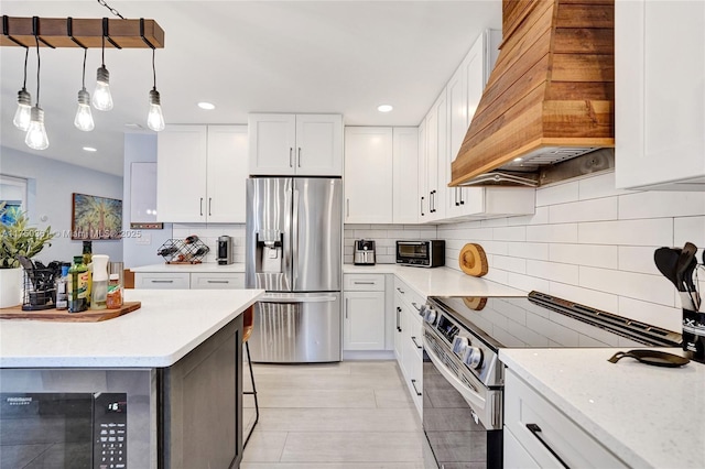 kitchen featuring hanging light fixtures, white cabinetry, custom exhaust hood, and stainless steel appliances