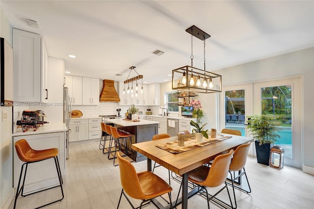 dining area with recessed lighting, visible vents, and french doors