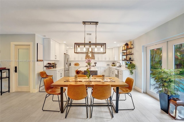 dining space with baseboards, visible vents, french doors, light wood-style floors, and recessed lighting