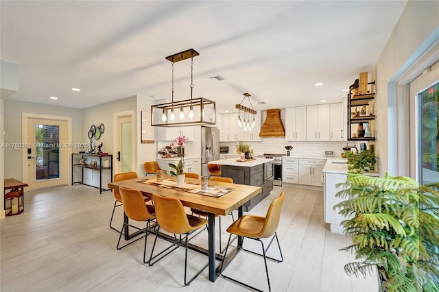 dining area featuring light wood-type flooring, visible vents, and recessed lighting