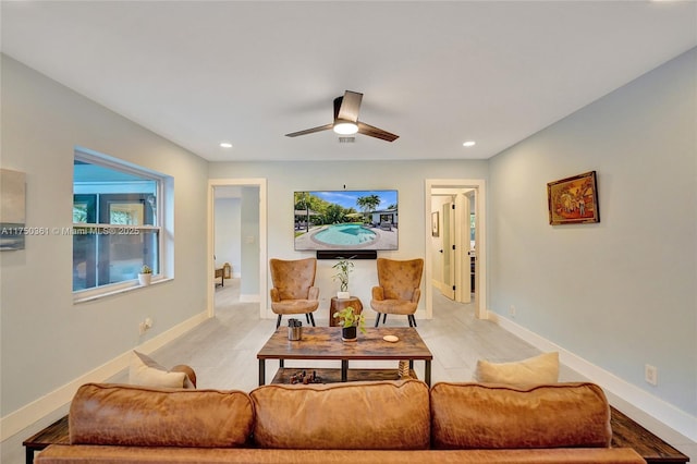 living room featuring a ceiling fan, recessed lighting, and baseboards