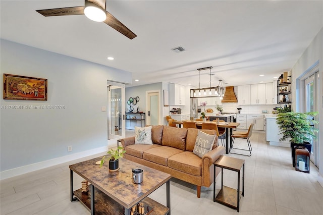 living area with french doors, recessed lighting, visible vents, a ceiling fan, and baseboards