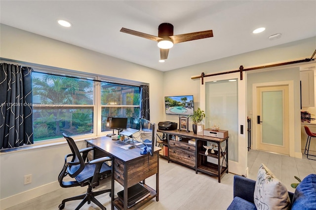 office area featuring a barn door, baseboards, a ceiling fan, light wood-style floors, and recessed lighting