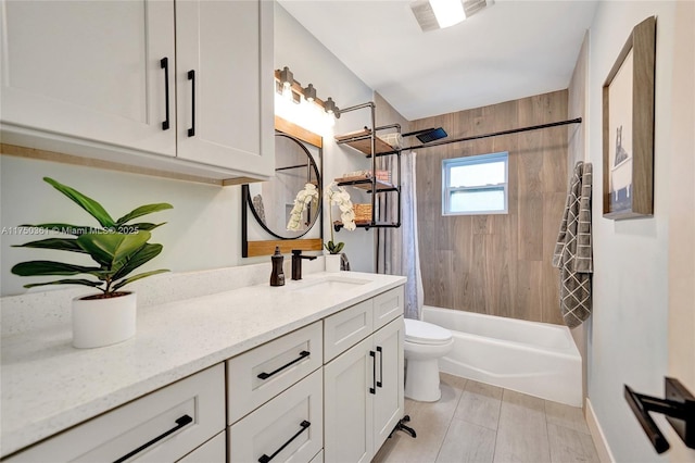 bathroom with toilet, shower / bath combo with shower curtain, vanity, and baseboards