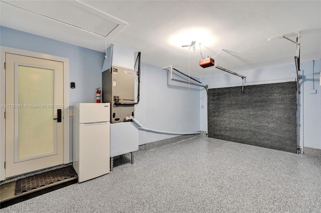 garage featuring freestanding refrigerator and a garage door opener