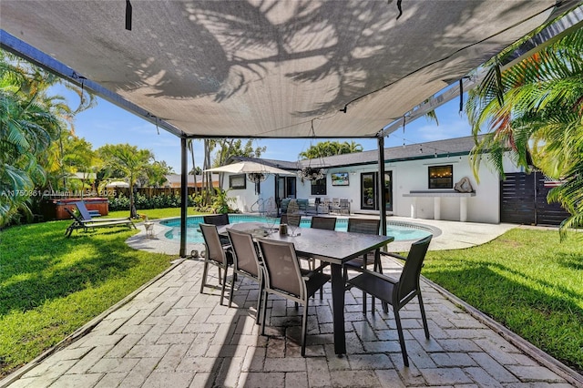 view of patio with a jacuzzi, fence, and an outdoor pool