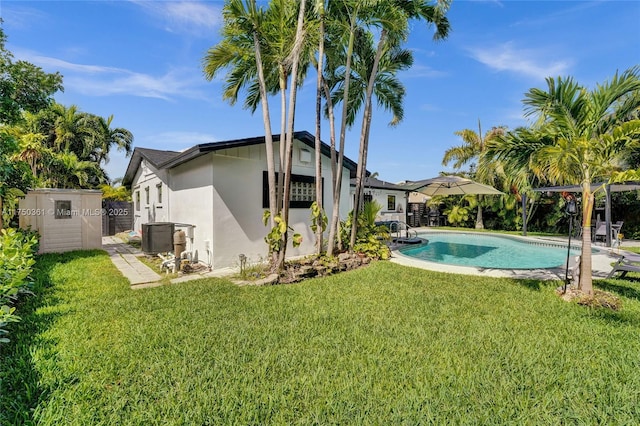 pool featuring a lawn and fence