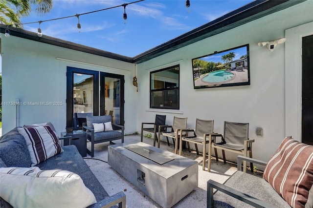 view of patio / terrace with an outdoor living space with a fire pit