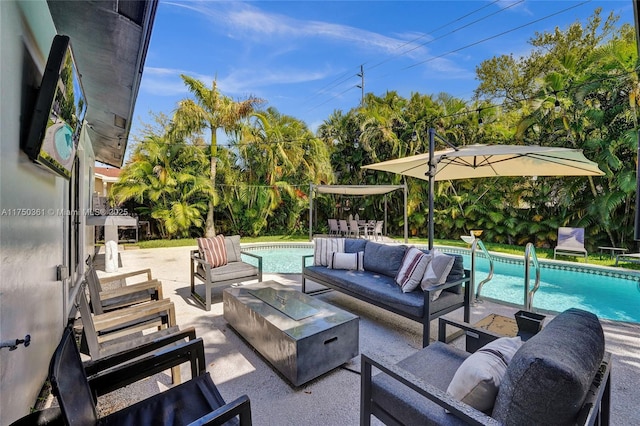 view of patio featuring an outdoor living space with a fire pit and an outdoor pool