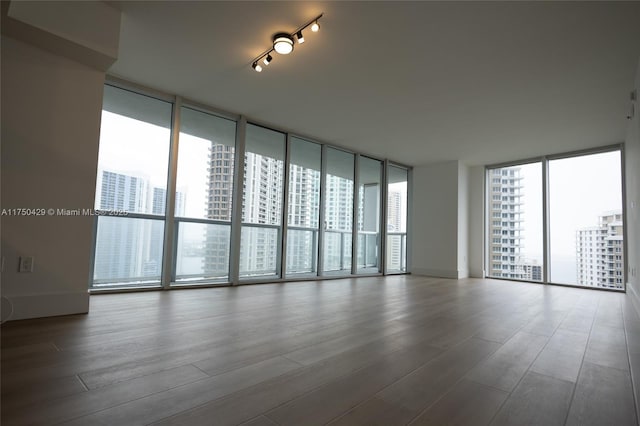 495 Brickell Ave Unit 2102, Miami, FL 33131 - spare room featuring a wall of windows, a city view, and wood finished floors