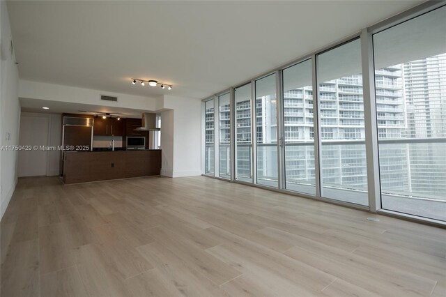 495 Brickell Ave Unit 2102, Miami, FL 33131 - spare room featuring light wood-style floors, expansive windows, visible vents, and a view of city