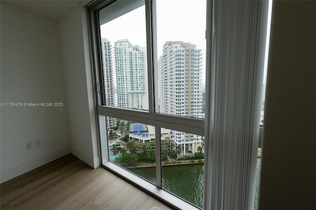 495 Brickell Ave Unit 2102, Miami, FL 33131 - interior space featuring a view of city, a water view, baseboards, and wood finished floors