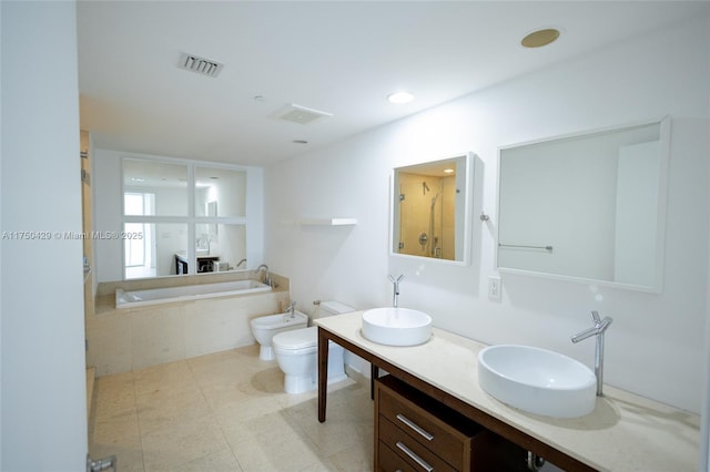 495 Brickell Ave Unit 2102, Miami, FL 33131 - bathroom featuring visible vents, a sink, a bidet, and a bath