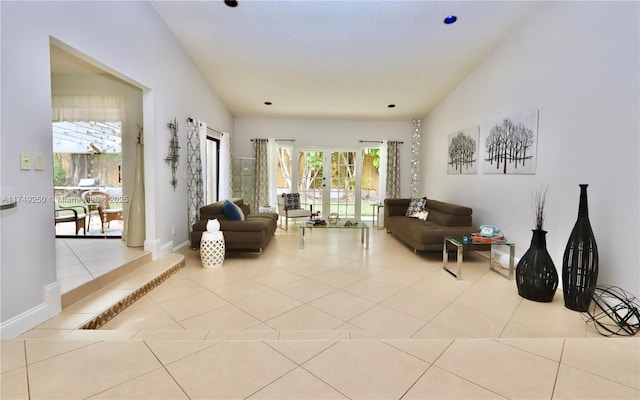 living area featuring a healthy amount of sunlight, lofted ceiling, and light tile patterned flooring