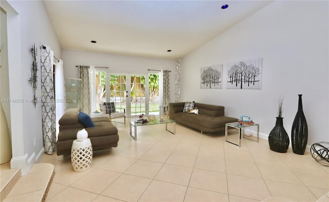 living room with lofted ceiling, baseboards, french doors, and light tile patterned flooring