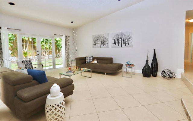 living room featuring french doors, light tile patterned flooring, vaulted ceiling, and baseboards