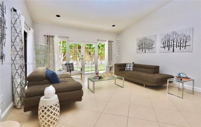 living room with light tile patterned floors, baseboards, vaulted ceiling, and french doors