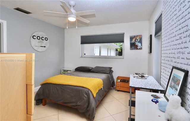 bedroom with light tile patterned floors, visible vents, and a ceiling fan