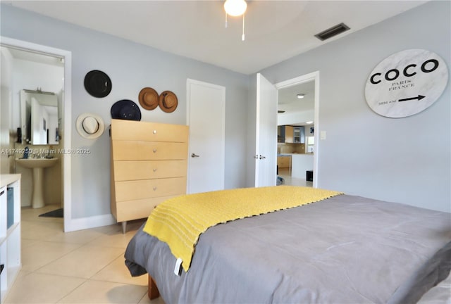 bedroom featuring light tile patterned flooring, visible vents, and baseboards