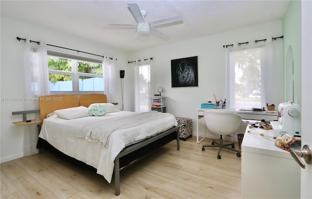 bedroom featuring light wood-type flooring, ceiling fan, and baseboards