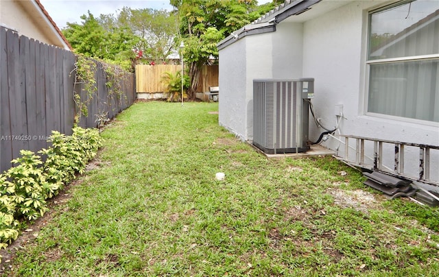 view of yard featuring a fenced backyard and central AC unit