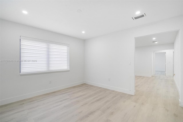 unfurnished room with baseboards, recessed lighting, visible vents, and light wood-style floors