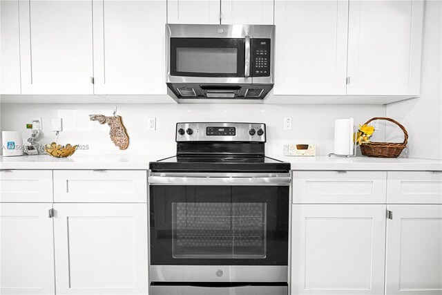 kitchen with white cabinets, appliances with stainless steel finishes, and light countertops