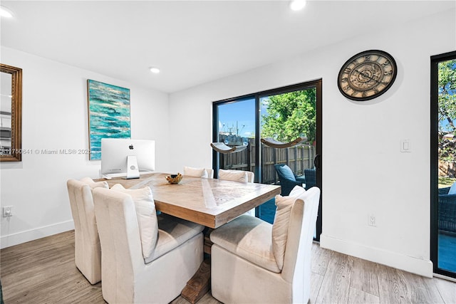 dining room featuring light wood-style flooring, baseboards, and recessed lighting