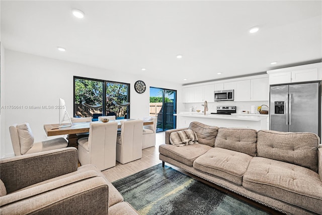 living area featuring recessed lighting and light wood-style floors