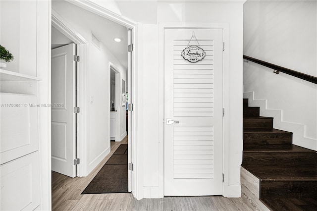 stairs featuring baseboards and wood finished floors