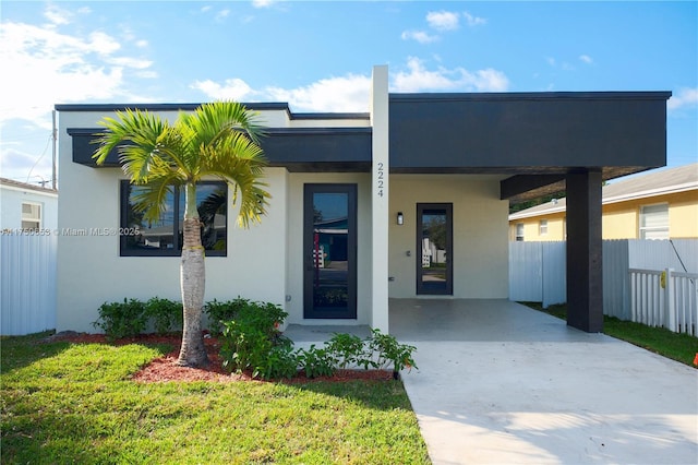 contemporary home featuring fence and stucco siding