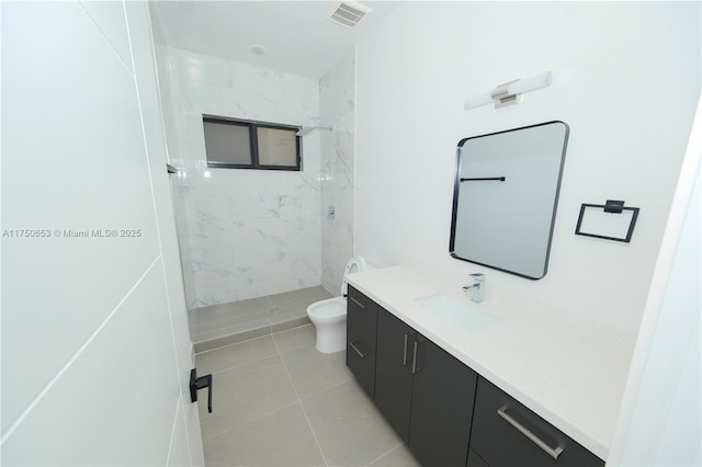 bathroom with tile patterned flooring, toilet, vanity, visible vents, and a marble finish shower