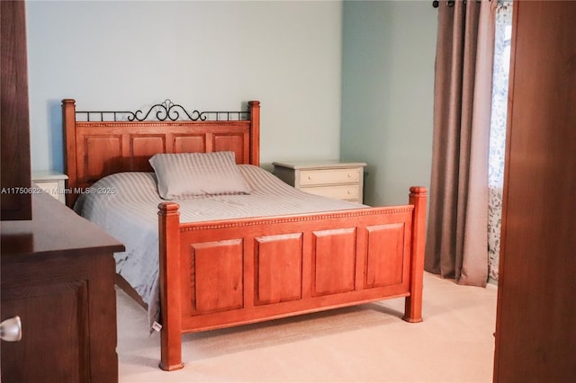 bedroom featuring light carpet