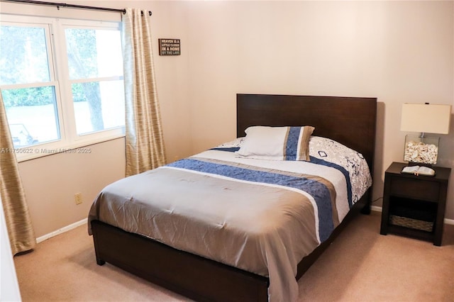 bedroom featuring carpet floors and baseboards