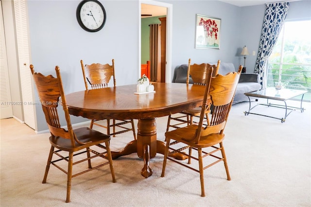 dining area with light colored carpet