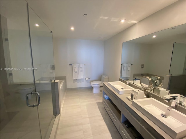 full bathroom featuring double vanity, recessed lighting, toilet, a sink, and a shower stall