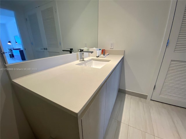 bathroom with vanity and baseboards