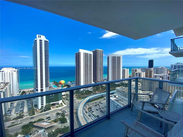 balcony with a view of city and a water view