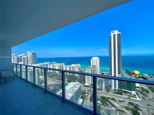 balcony featuring a city view and a water view