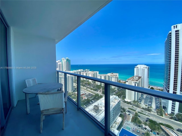 balcony with a water view and a city view